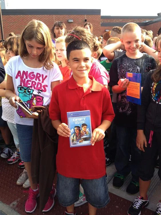 Francis Bellamy Student Proudly Holds His New Book From the Duffy Books in Homes Program